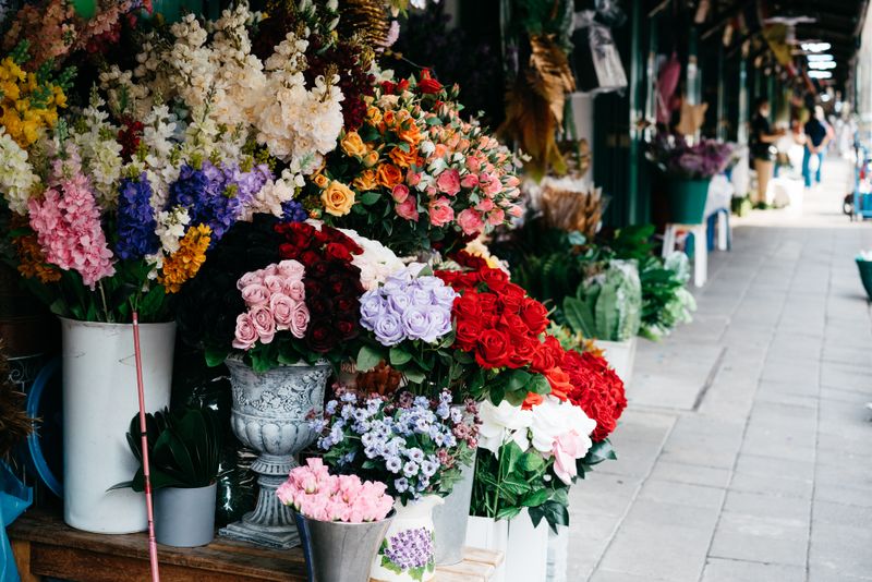 flower shop business for sale - florist preparing bouquet at counter